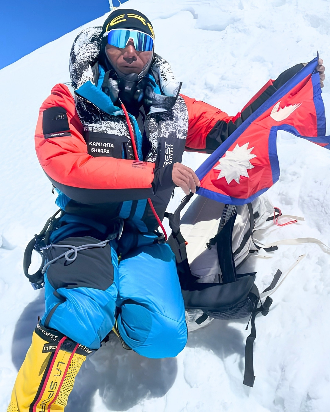 image-of -kami-rita-sherpa-holding-nepal-flag-at-top-of-everest